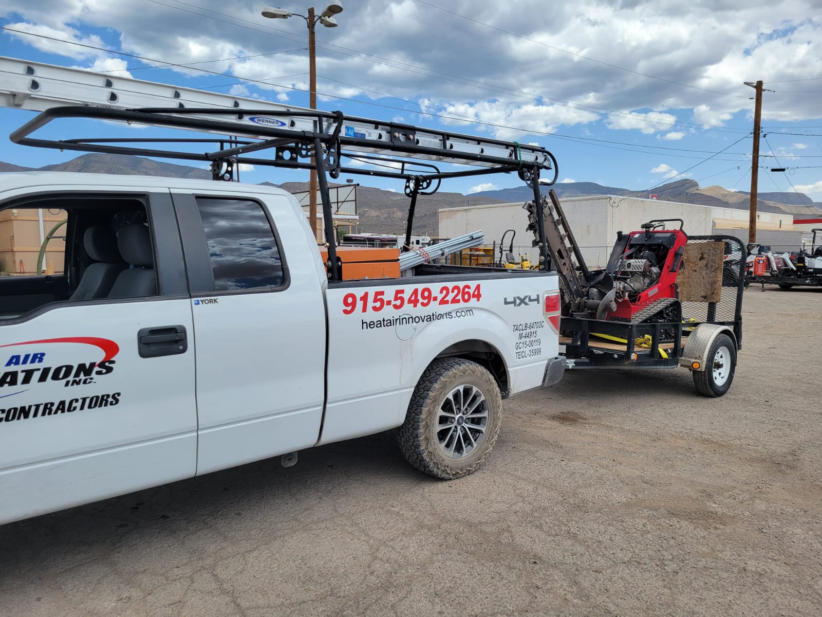 Company excavator and service truck on an El Paso job site
